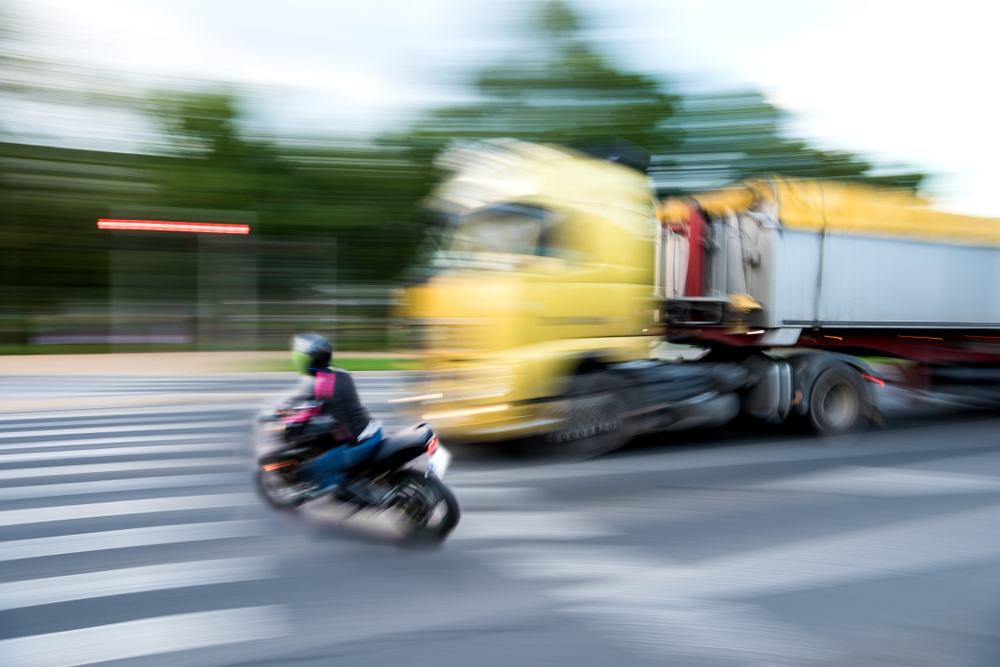 truck colliding with motorcyclist
