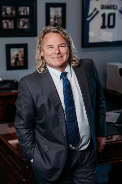 LJ Leatherman - personal injury attorney - in office with charcoal colored suit